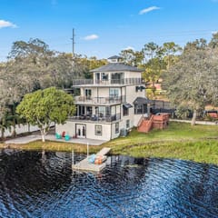 Sprawling river view estate with game room dock kayaks grill and fishing gear