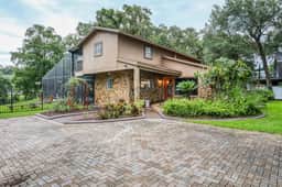 Riverfront retreat with pool spa outdoor kitchen firepit dock sauna and games