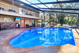 Riverfront retreat with pool spa outdoor kitchen firepit dock sauna and games - Image 2