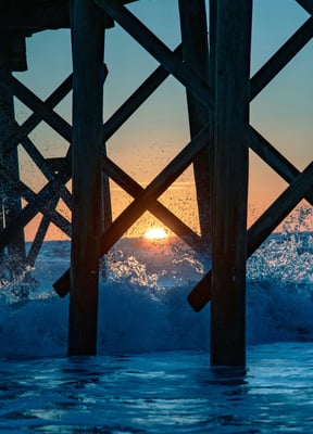 Sunset under a pier at Indian Rocks Beach