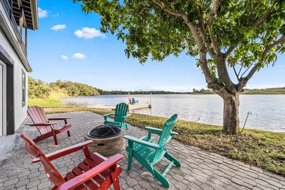 Sprawling river view estate with game room dock kayaks grill and fishing gear