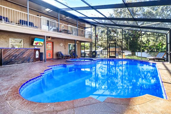 Riverfront retreat with pool spa outdoor kitchen firepit dock sauna and games - Image 2
