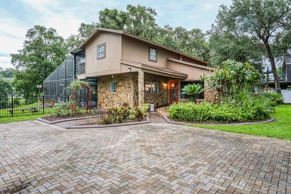 Riverfront retreat with pool spa outdoor kitchen firepit dock sauna and games - Image 1